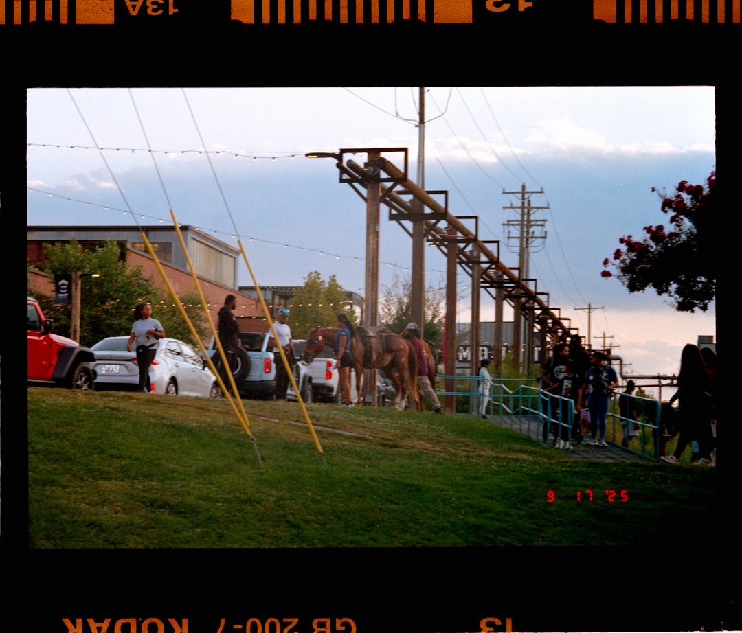 Field production crew setting up camera positions at an outdoor event